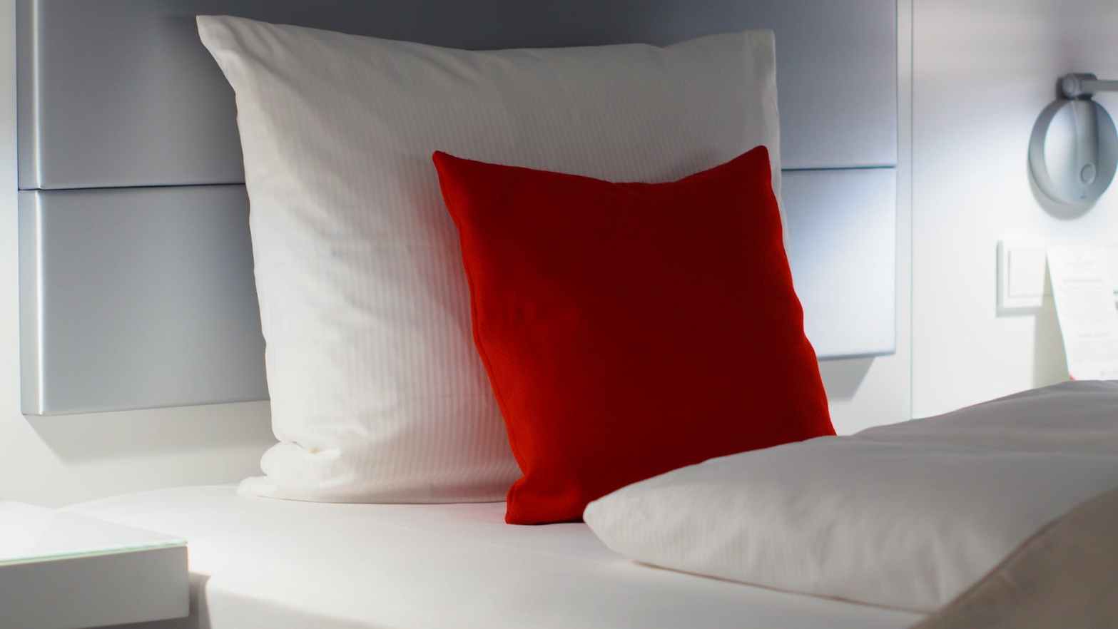 red and white bed pillows