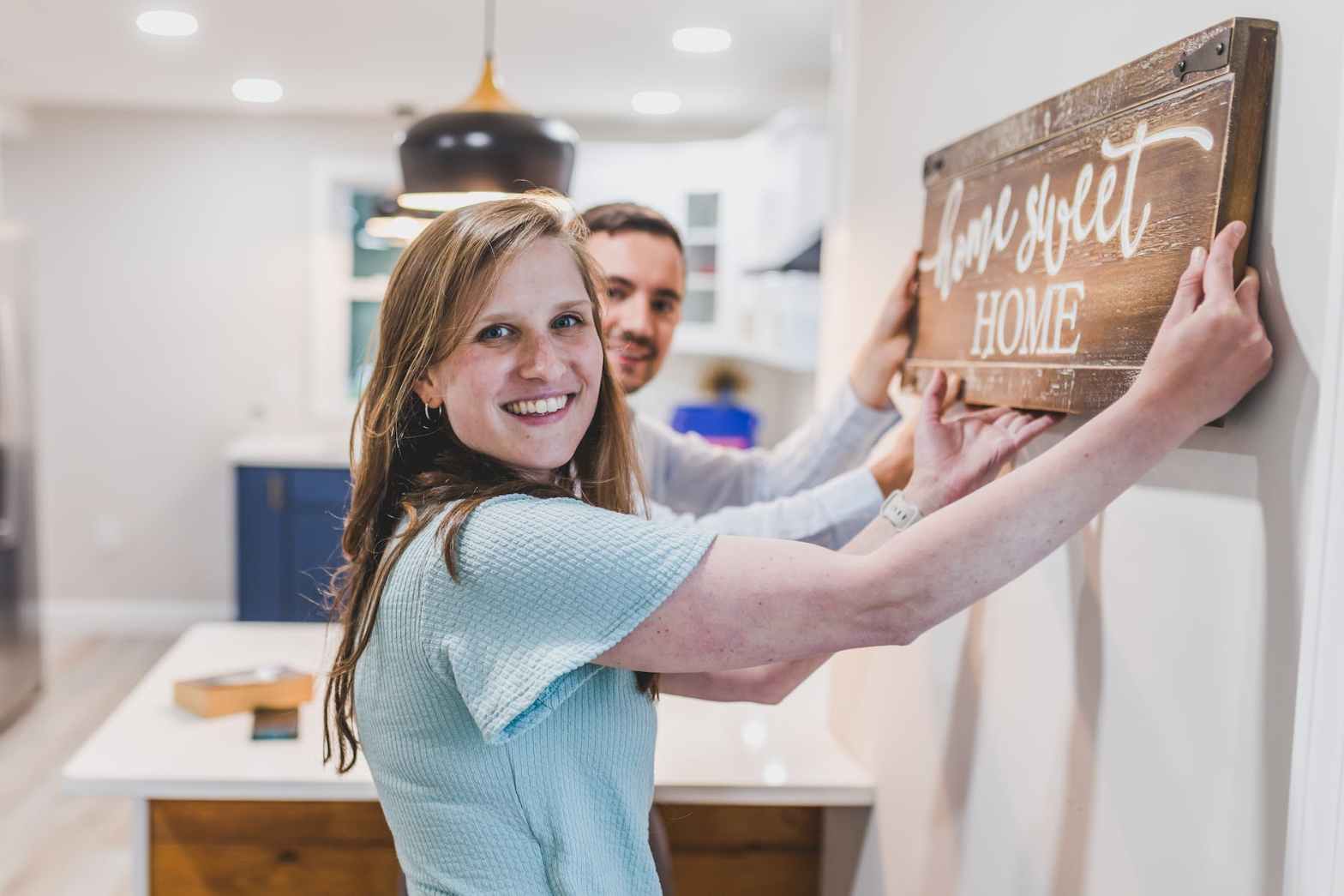 a woman holding a wooden plank